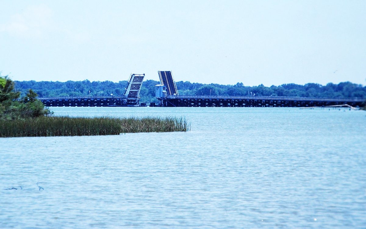 A 1984 view of a since-removed bridge that once carried Tri-City Beach Road over Cedar Bayou, in Baytown, Texas, with its bascule draw span opened.   This is a digitized Kodachrome slide from August 1984.  The bridge was removed in the mid- to late 1980s and not replaced.