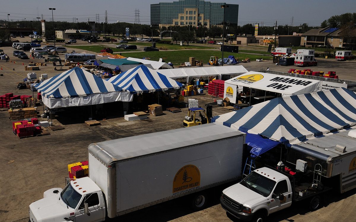 Baytown, TX, September 28, 2008 -- An aerial view of the North Carolina Baptist Men's disaster kitchens Manna 1 (left center), Unit 2 (right), and Unit 3 (left), a FEMA commodity Point of Distribution (POD) (upper left center), and a Red Cross command center. The three kitchen complex can cook and distribute 70,000 meals per day; 2 weeks after Hurricane Ike and this kitchen group is still sending out 7000 meals per day. Mike Moore/FEMA