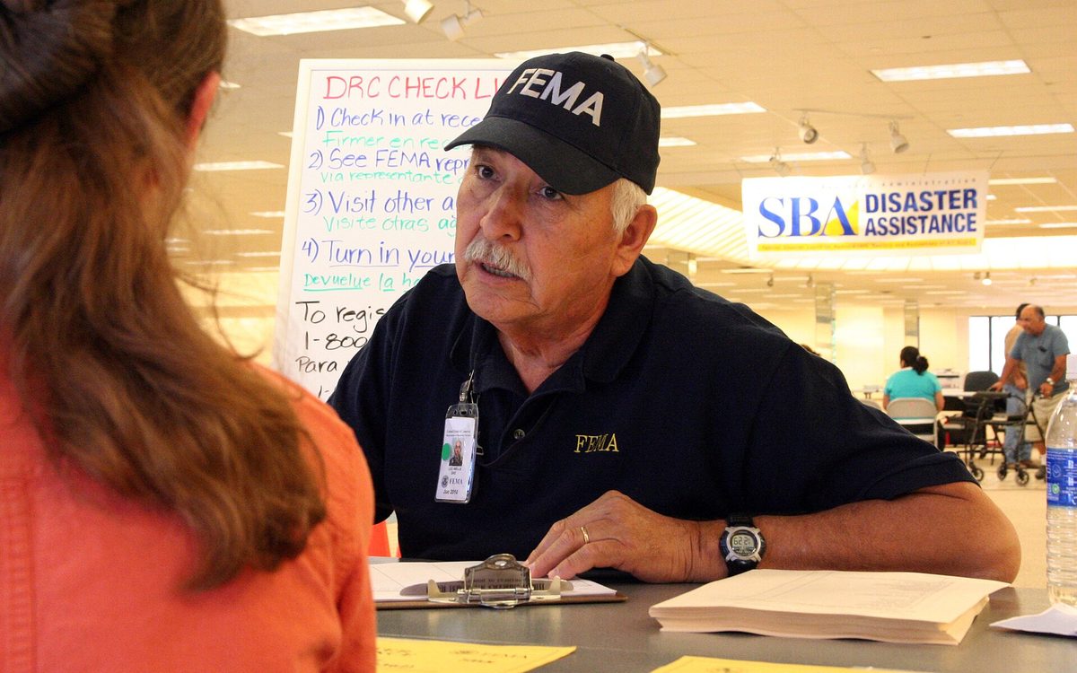 Baytown, TX, October 1, 2008 -- FEMA Community Relations Specialist Leo Wells explains the registration process to an applicant at the Disaster Recover Center in the San Jacinto Mall.  FEMA has twenty DRCs open in several east Texas counties for residents who sustained damage from Hurricane Ike.  Photo by Greg Henshall / FEMA