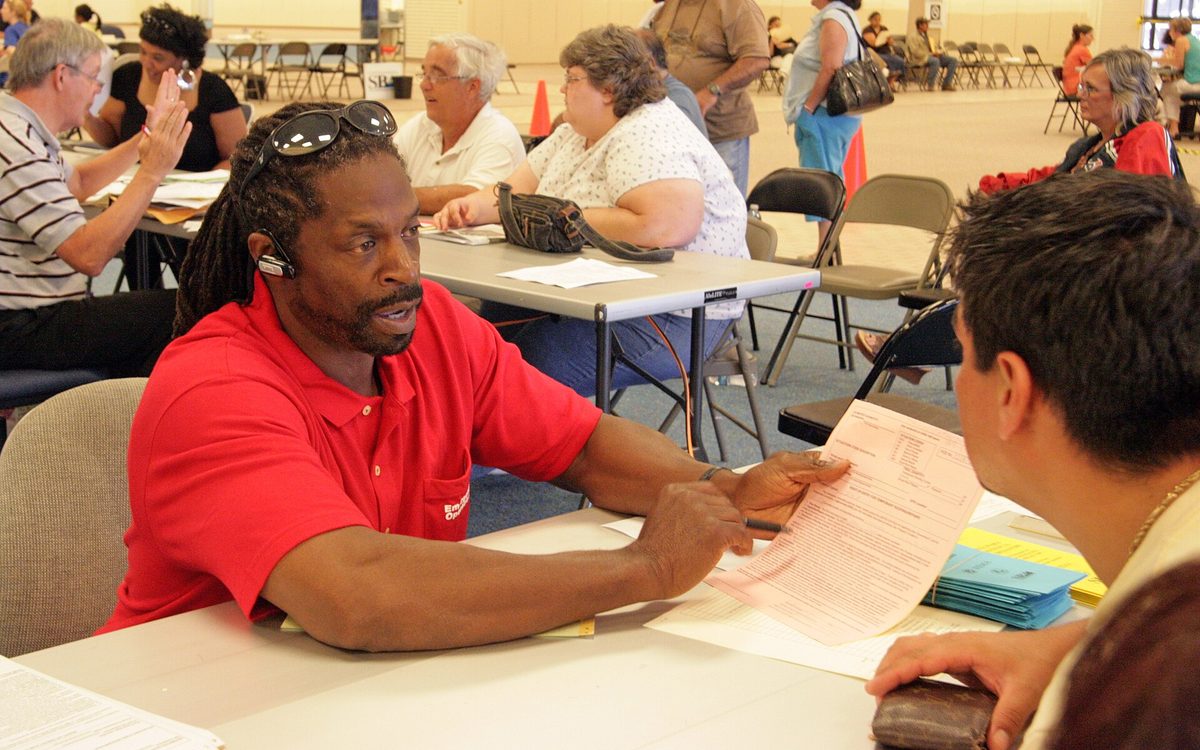 Baytown, TX, October 1, 1008 -- Thomas Cathey with the U.S. Army Corps of Engineers explains the "Blue Roof" operation to a resident who suffered damage to his house from Hurricane Ike.  FEMA opened this Disaster Recovery Center at the San Juacinto Mall three days ago.  Photo by Greg Henshall / FEMA