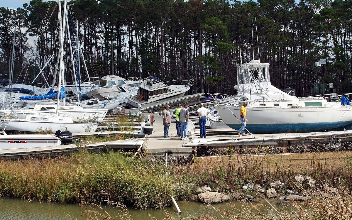 Baytown, TX, October 13, 2008 -- Contractors look over the Baytown Marina, where Hurricane Ike's storm surge pushed over seventy boats and their piers out of the water and onto dry land.  Baytown will be using FEMA Public Assistance grants to fund the restoration of the city-owned marina.  Photo by Greg Henshall / FEMA