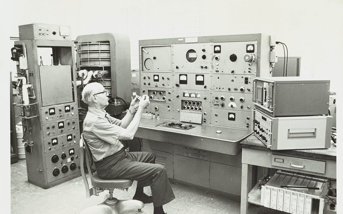 Consolidated Engineering Corporation Model 21-103 Mass Spectrometer in use at the Exxon Research and Engineering Company analytical research laboratory located in Baytown, Texas. Laboratory Technician Glyn R. Taylor is seen preparing a sample for insertion into the mass spectrometer's heated inlet system.