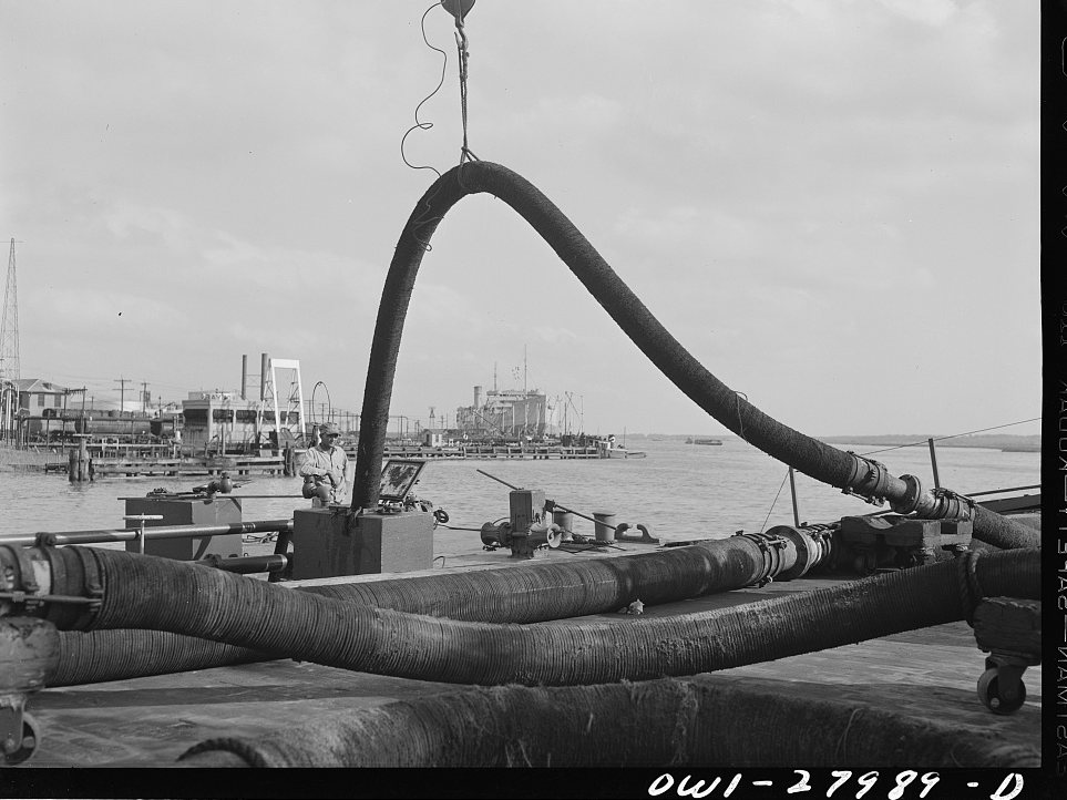 Baytown, Texas. Barge being loaded with oil at a refinery